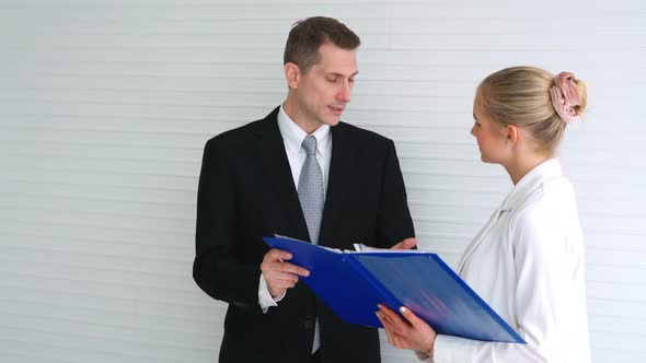 Two Business People Talk Project Strategy at Office