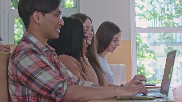 Groupmates Talking, Using Laptops in University