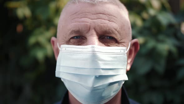 Close Up Portrait of Mature Man Wearing Medical Protective Mask