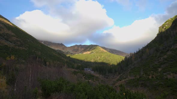 Beautiful panoramic pan shot of a mountain valley surrounded by high altitude peaks in High Tatras,