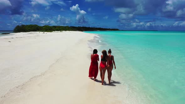 Beautiful ladies tan on marine coast beach break by blue lagoon and white sandy background of the Ma