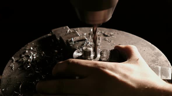 Metal Drilling Closeup in Metal Workshop. Drilling Machine Making a Hole in a Steel Bar