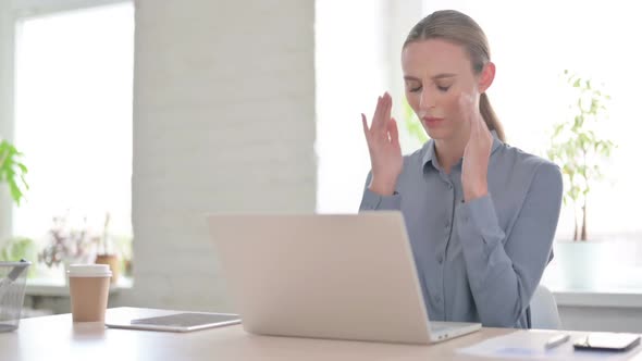 Woman Having Headache While Working on Laptop