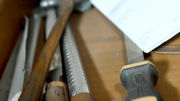 Various tools arranged on wooden table in workshop 4k