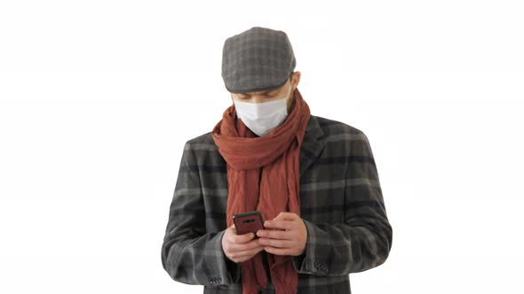 Gentleman in Medical Mask Using Phone and Walking on White Background