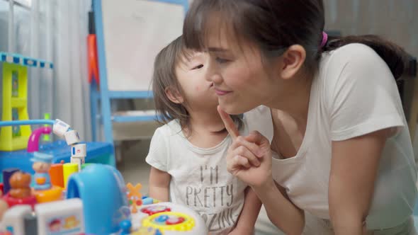 Asian happy family, beautiful mother and little girl kid playing toy together in living room at home