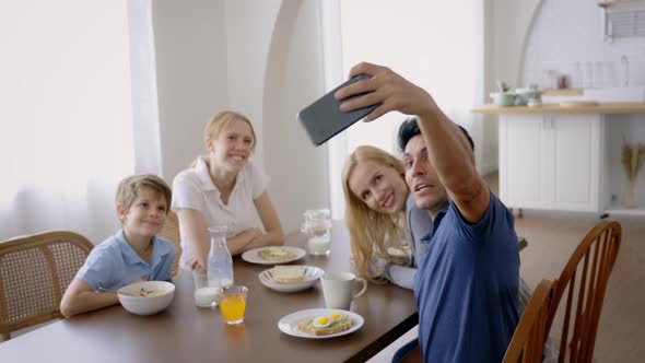 Father Taking Selfie While Eating Breakfast