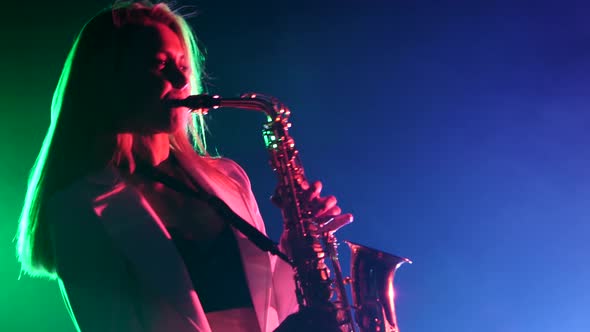 Young Sexy, Blonde Woman Dj in White Jacket and Black Top Playing Music Using Saxophone, Flipping