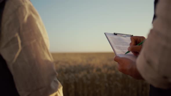 Partners Signing Contract Wheat Field