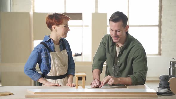 Carpenter and Customer Discussing Woodworking Project Making Furniture