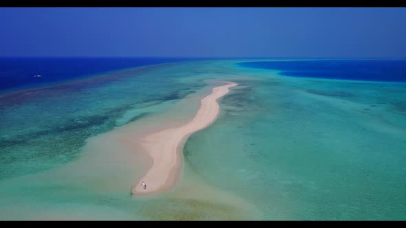 Aerial flying over nature of tropical coastline beach break by aqua blue ocean with bright sand back