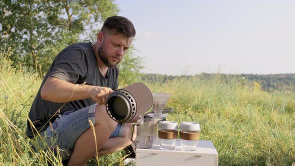 Middleaged Male Making Coffee in Nature Summer Sunny Day