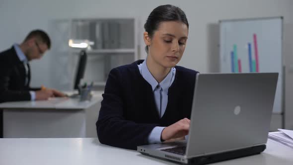 Female Manager Typing on Laptop and Smiling at Camera, Workday in Big Company