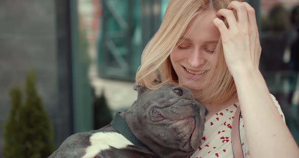 Beautiful Young Girl Holding Adorable French Bulldog Puppy