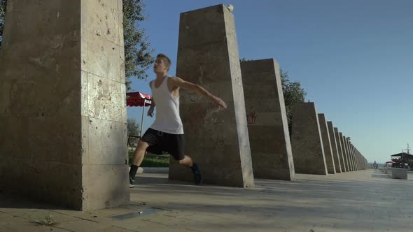 Young man doing tumbleset trick in the city