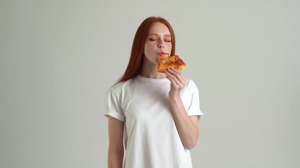 Portrait of Attractive Happy Young Woman with Appetite to Eat Delicious Pizza and Looking at Camera