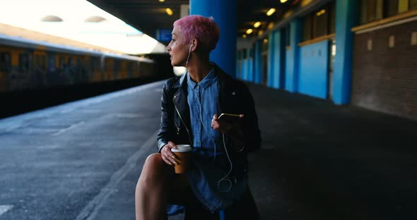 Pink Hair Woman Listening Music on Mobile Phone 