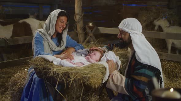 Happy Mary and Joseph with Baby Jesus Near Stalls