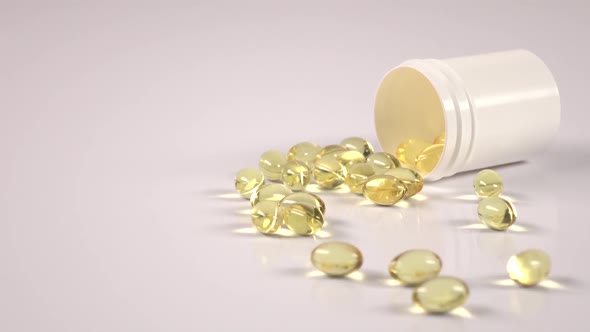 Fish Fat Oil Capsules Are Scattered Off of the Medical Jar, Rolling Away on White