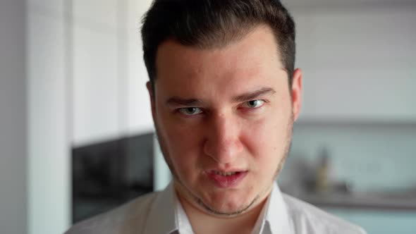 Portrait evil young man looking at camera. Angry person emotional watching intro the camera