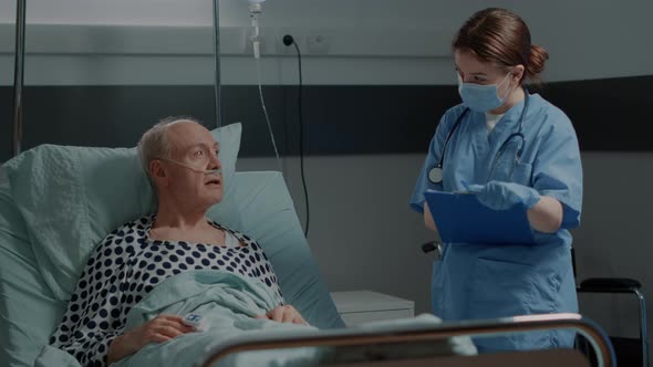 Hospital Ward Nurse Checking on Sick Patient