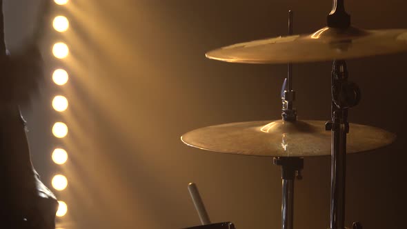 Hands Drummer Playing on Drum Kit on Stage in a Dark Studio with Smoke and Neon Lighting. Dynamic