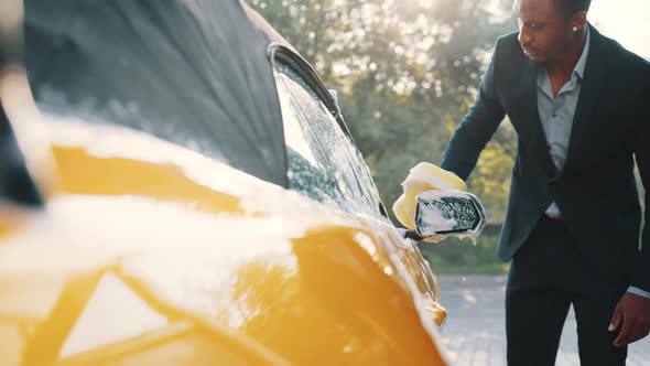 Young Attractive African American Man in Business Suit Washing Outside Rearview