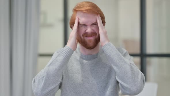 Portrait of Young Redhead Man Having Headache
