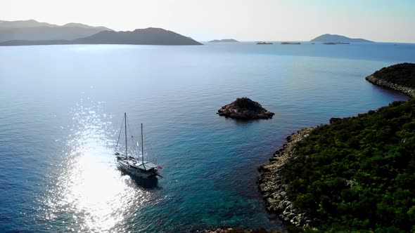 Aerial View of Beautiful Large Yacht Stands Near Green Shore on Sea or Ocean