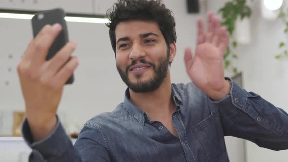 Video communication. Man making video call on phone indoors