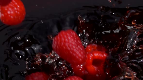 Ripe Red Raspberries Fall Into Juice