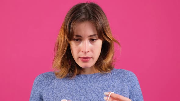 Woman Nods and Puts a Mask on Her Face From Air Pollution and Coronavirus