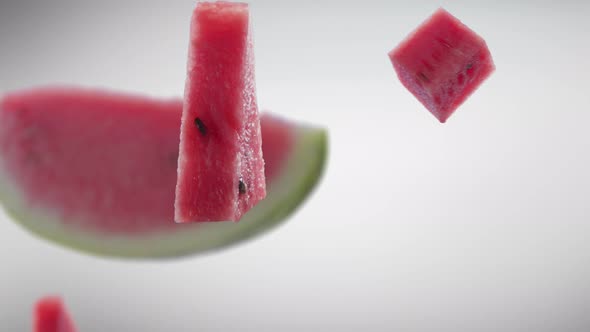 Flying of Watermelon and Slices in Grey Background