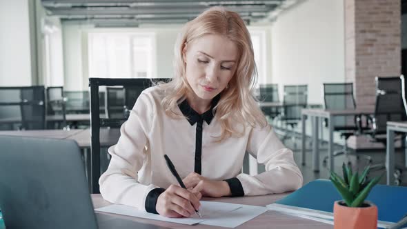Woman Writing Message at Workplace