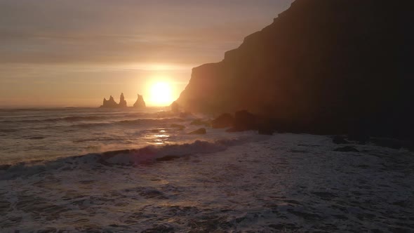 Drone Towards Reynisdrangar Sea Stacks At Sunset