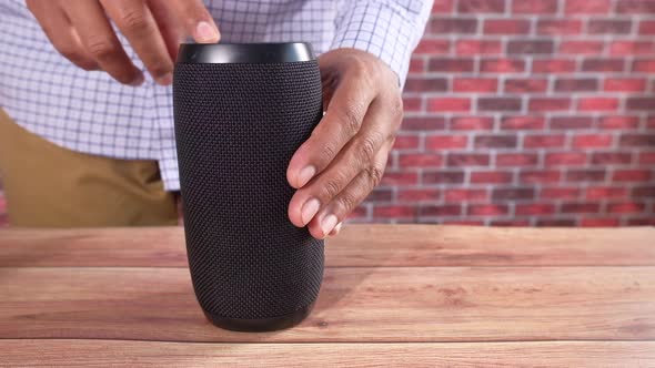 Young Man Using Smart Speaker on Table