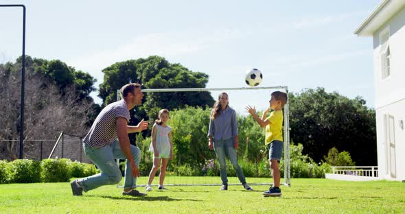 Happy family playing football