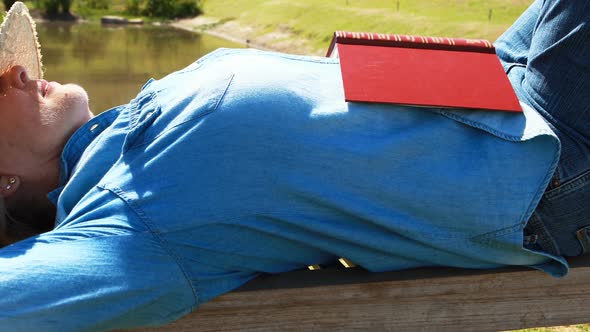 Senior woman sleeping on the bench