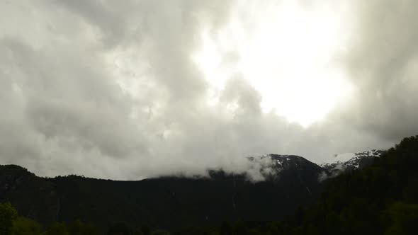 Time lapse shot of low clouds moving over mountains