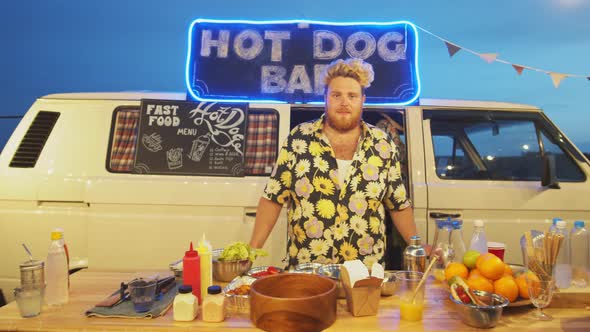 Portrait of Cheerful Male Seller by Food Truck