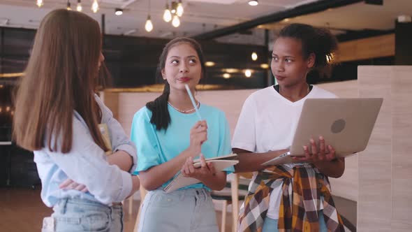 A group of friends discussing homework in a coffee shop.