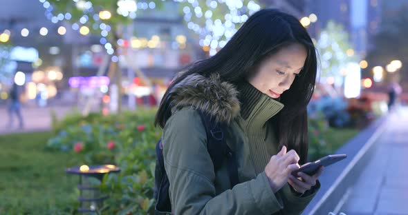 Woman Using Smart Phone at Night