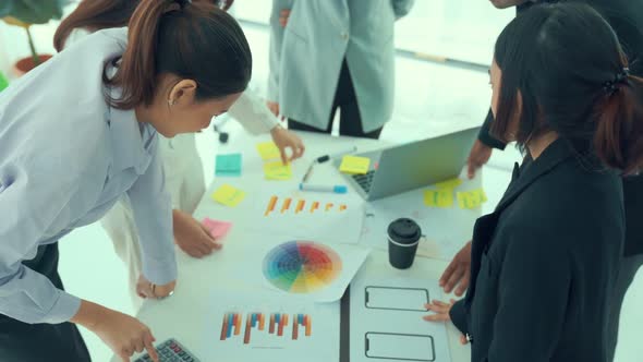 Business People Proficiently Discuss Work Project on Meeting Table