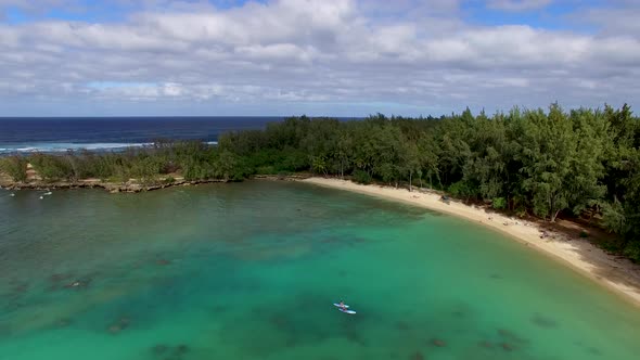 Aerial shot of turquoise Hawaiian waters of Kawela Bay Beech Park near the Turtle Bay Resort.