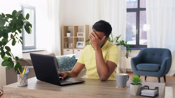 Indian Man with Laptop Working at Home Office