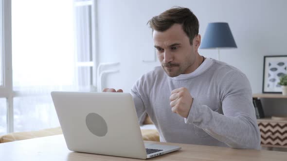 Excited Adult Man Celebrating Success Working on Laptop