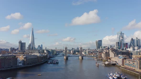 Slow descending drone shot of tower bridge and Central London over river thames