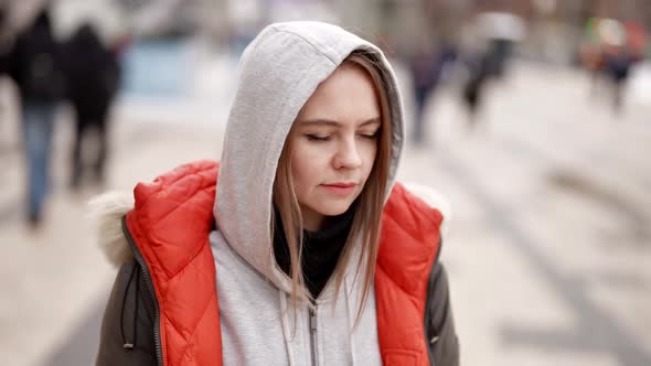 Portrait of Frustrated Young Woman in City Center in Autumn Day Lady is Wearing Hood