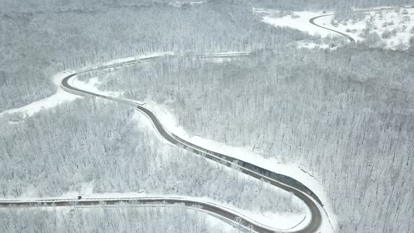 Drones Eye View  Winding Road From the High Mountain Pass in Winter