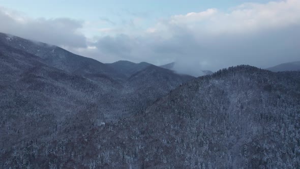 Aerial View of the Mountains Range with Clouds and Storm Clouds in Twilight